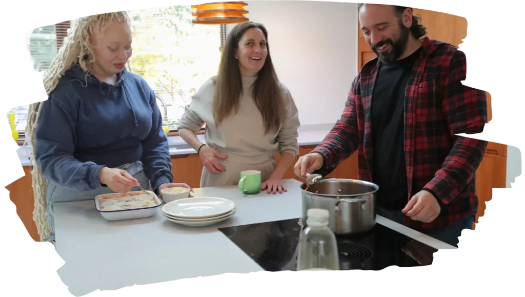 Three diverse friends cooking at home