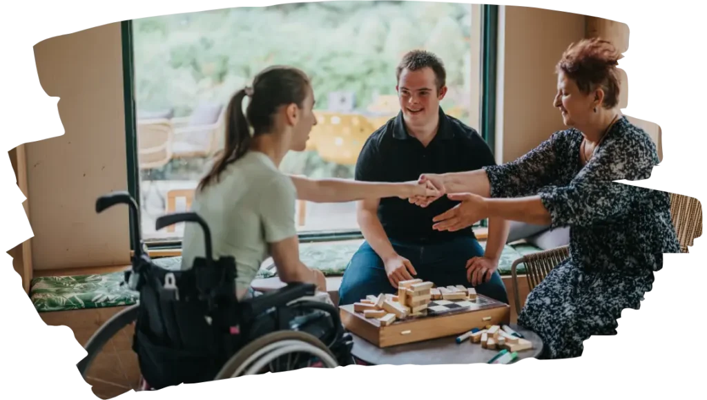Two disabled friends with support worker